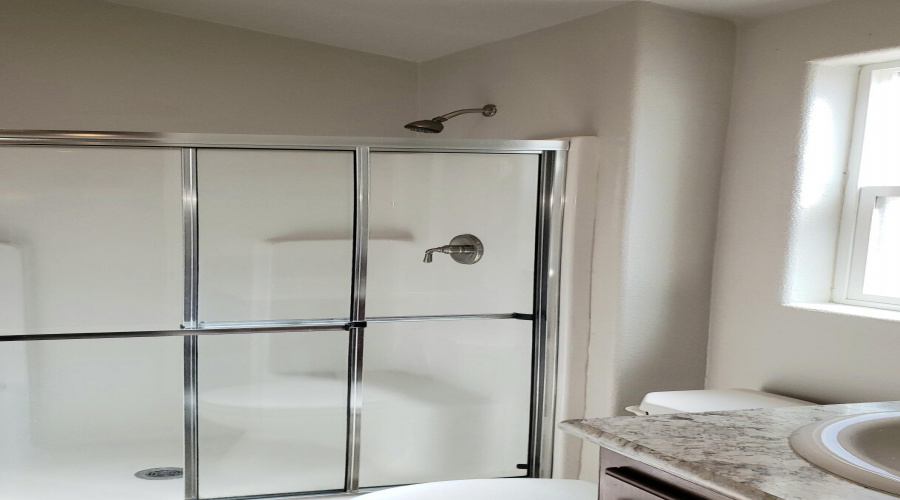 Bath Shower has glass doors
