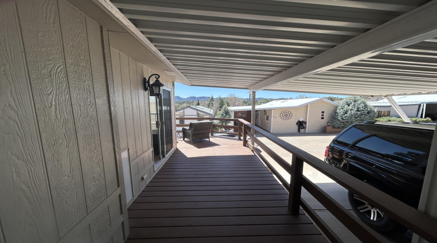 Lengthy deck beside carport