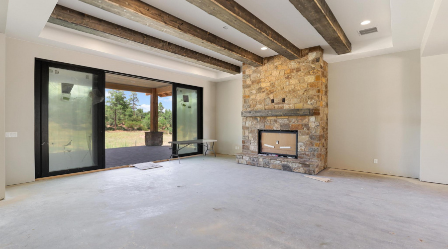 Great Room with Beamed Ceiling and Stone