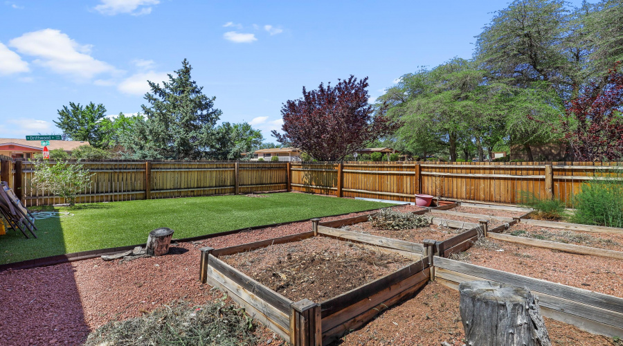 Side Fenced Yard with Garden Beds