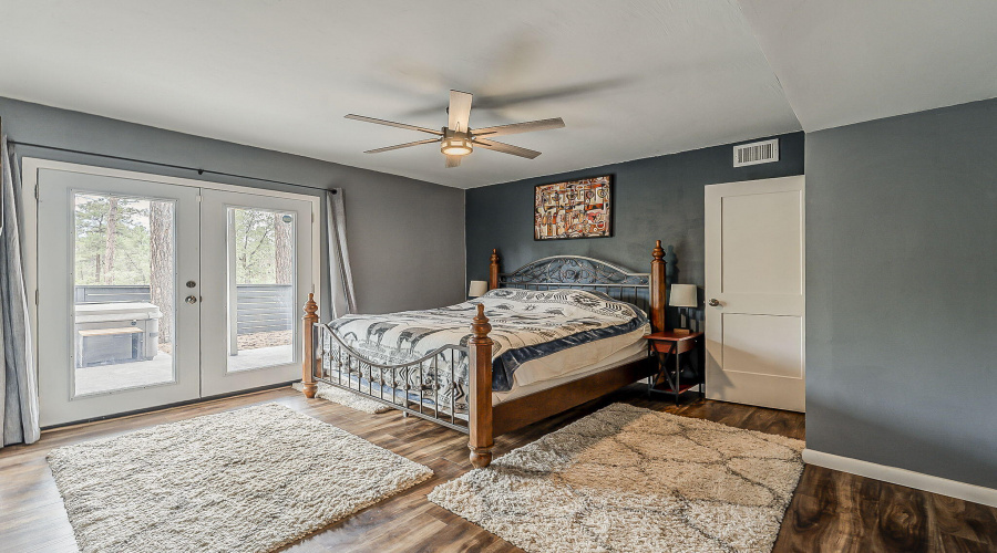 Primary Bedroom with doors to backyard
